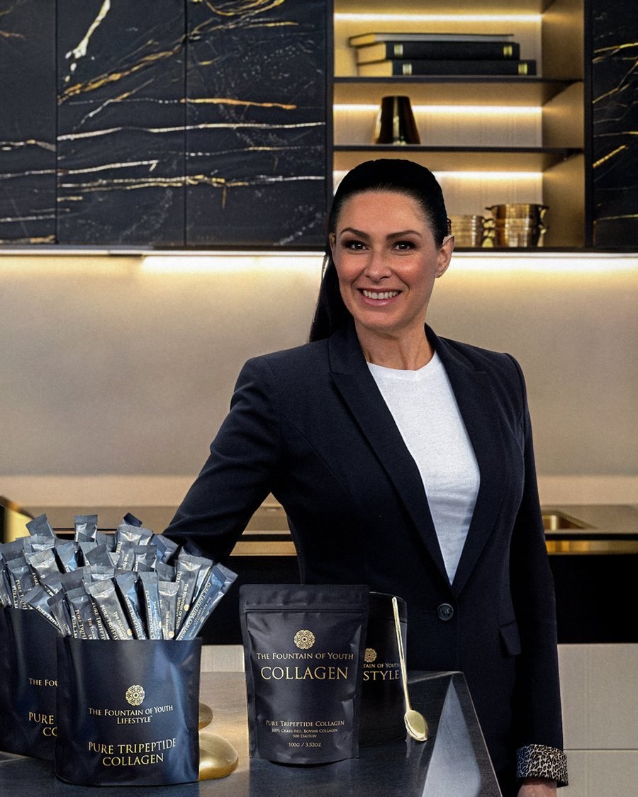 Jacqui Hutton, founder, standing behind Pure Tripeptide Collagen 100g bags