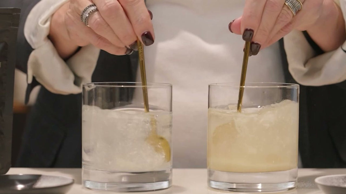 Both glasses being stirred in the spot: the tripeptide collagen clearing on the left, the other collagen staying cloudy on the right