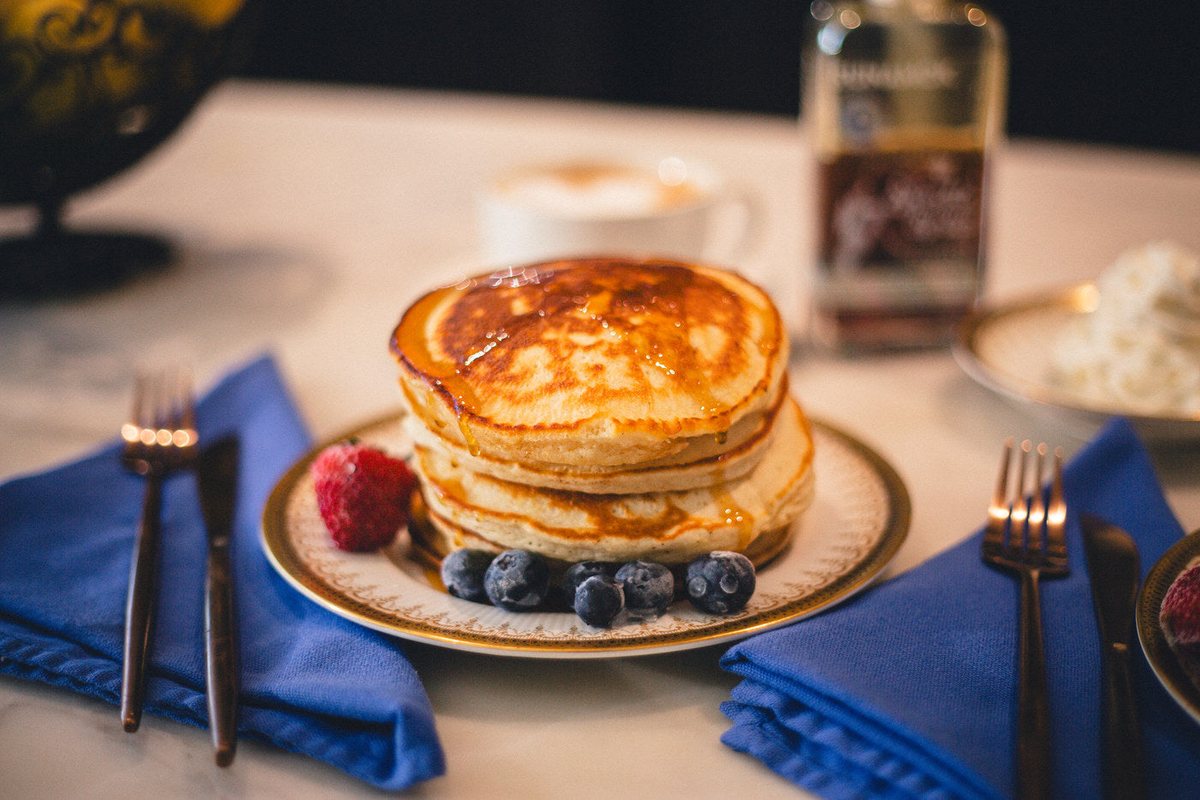 A stack of pancakes with blueberries and syrup, a recipe from the cookbook